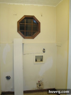 Before photo of the old, unorganized laundry room