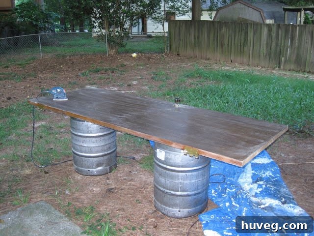Empty kegs used as sawhorses for painting doors