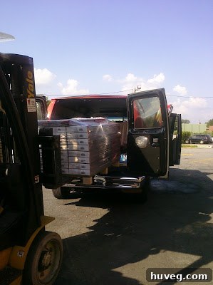 Flooring palette being loaded into a van with a forklift