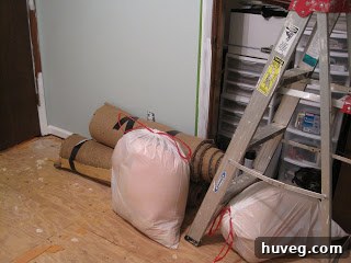 Pile of old carpet rolled up and ready for disposal or repurposing.