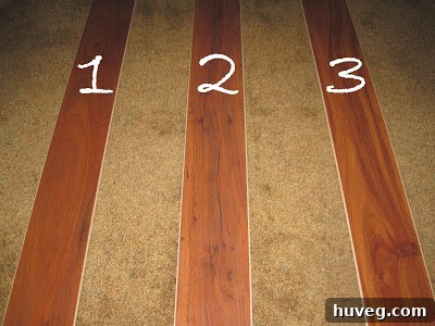 Three different laminate flooring samples laid out for comparison.