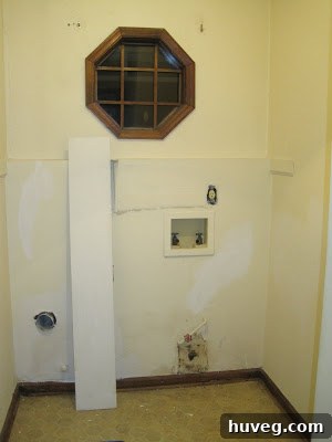 Large hole in a damaged wall, highlighting the need for drywall repair