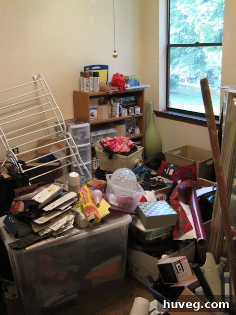 Another angle of the craft room before, showcasing disorganization and plain walls.