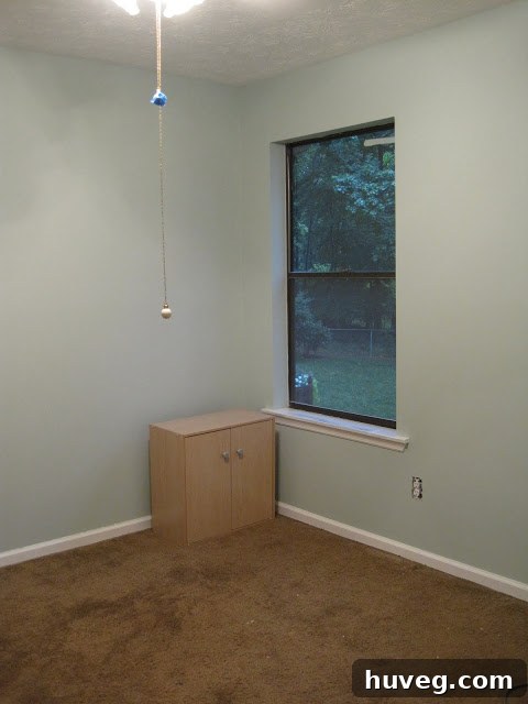 After image of the craft room, showcasing vibrant teal walls with white trim, looking fresh and inviting.