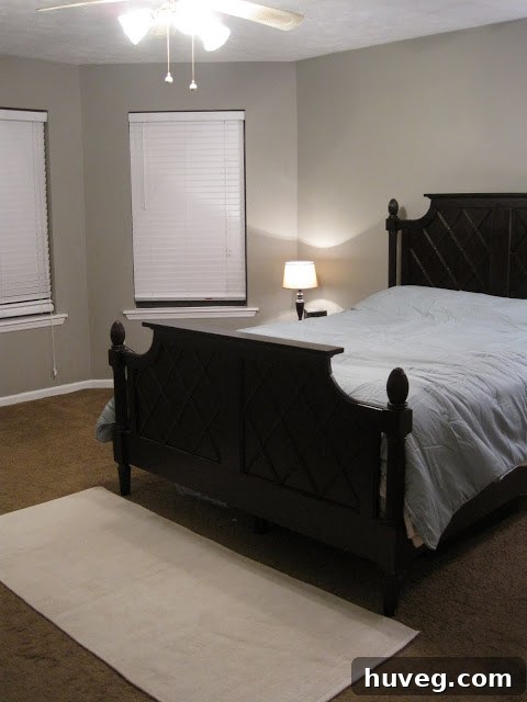 Primary bedroom after painting, showing new gray walls and white trim, taken in the evening light