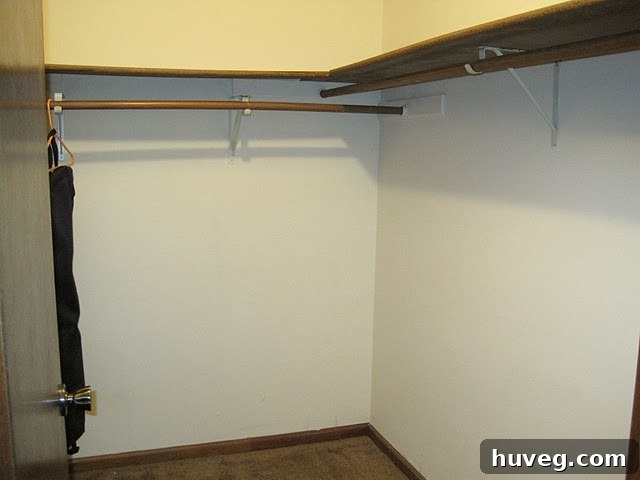 Before image of a disorganized closet with old, warped shelves and a pile of mixed hangers
