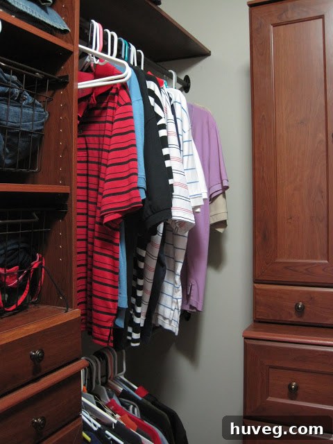 Detailed view of an organized section of the closet with hanging clothes and folded items