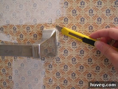 Trimming wallpaper around towel bar