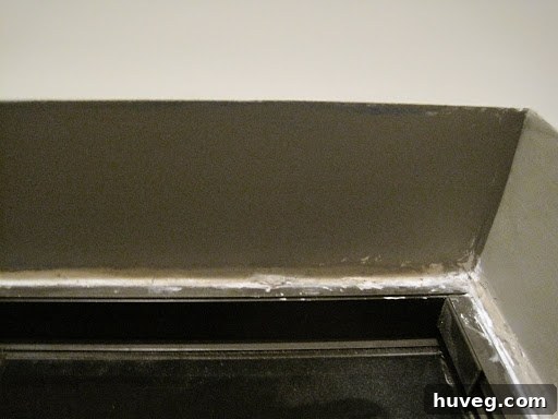 Finished window frame with the gap expertly sealed by expanding foam, ready for paint