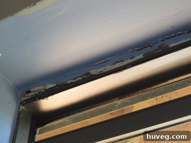 Old, cracking caulk around a window frame needing repair