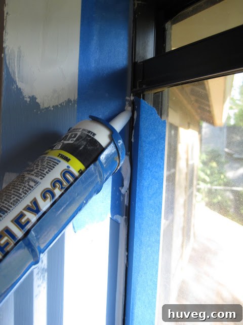 Close-up of caulk being smoothly applied and finished on a window frame