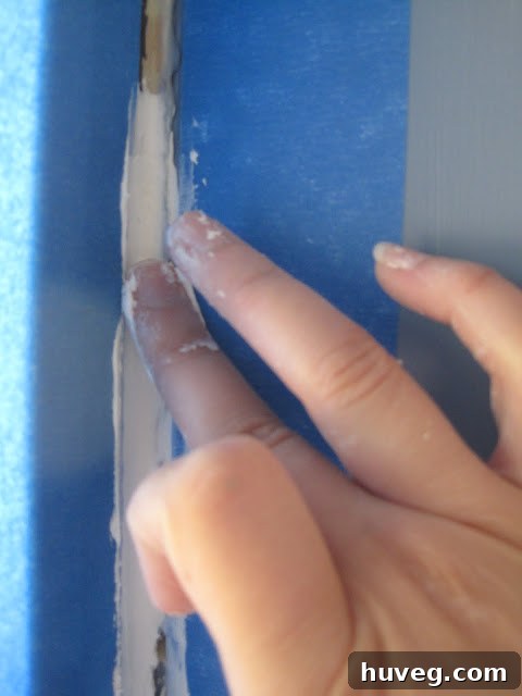 Another view of a DIY window caulking project in progress