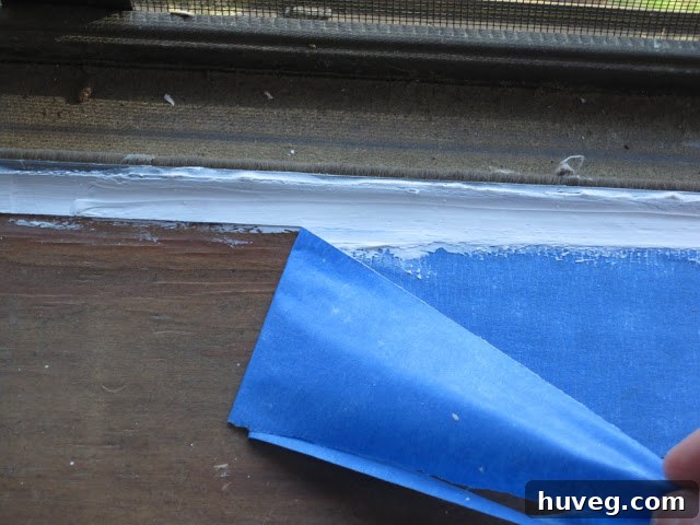 Finished caulk line after tape removal, showing a clean, sealed edge