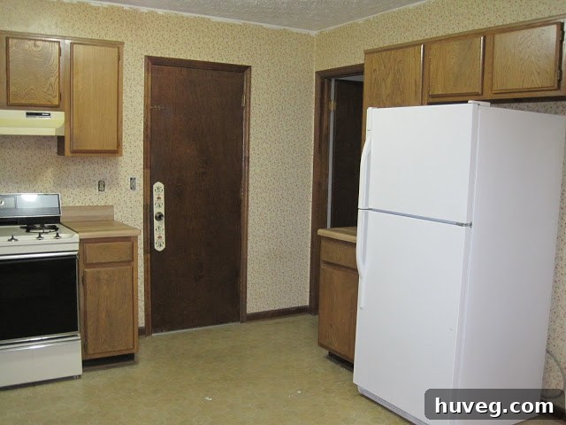 Another view of the kitchen before renovation, emphasizing its dated appearance and lack of modern amenities.