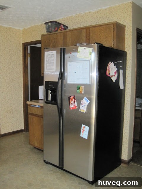 New stainless steel refrigerator installed, making a significant positive difference in the kitchen's modern appeal.