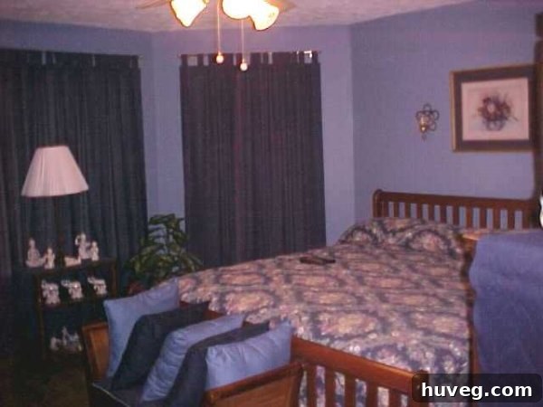 A super dated primary bedroom with a blue color scheme, indicating its pre-renovation state.