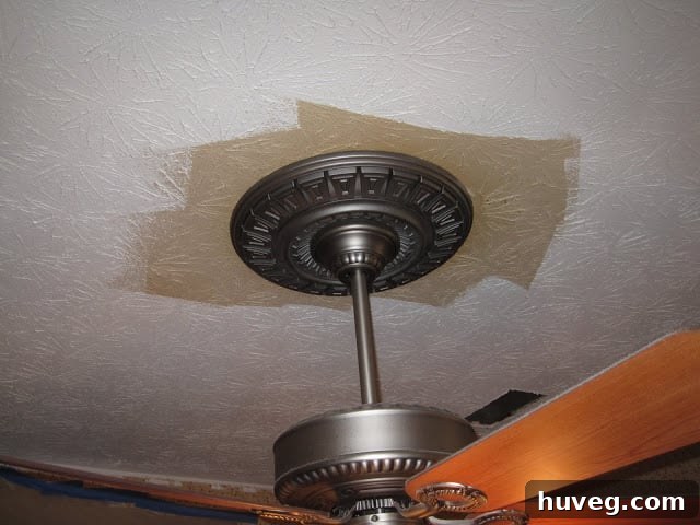 Comparison showing new white ceiling paint against a heavily yellowed ceiling, highlighting the extent of past smoke damage.