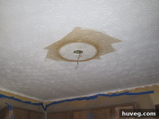 Another view of the dramatic difference between freshly painted white ceiling and the old, discolored ceiling.