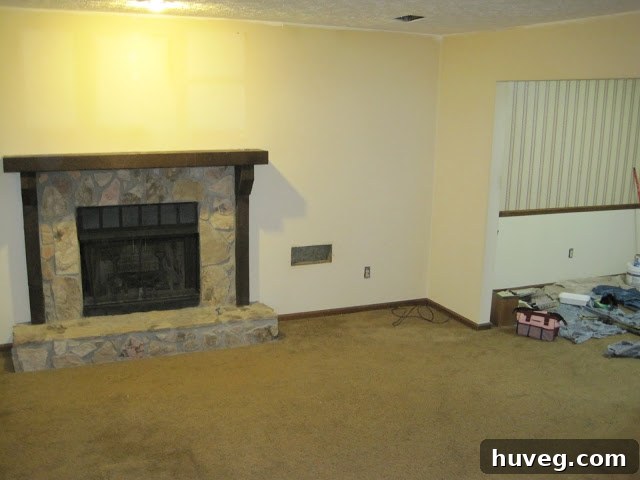 Another perspective of the living room before paint, highlighting its dated appearance.