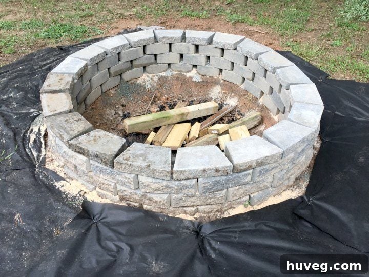 Optional stone caps complete the fire pit, giving it a polished and refined appearance, significantly enhancing its aesthetic appeal.