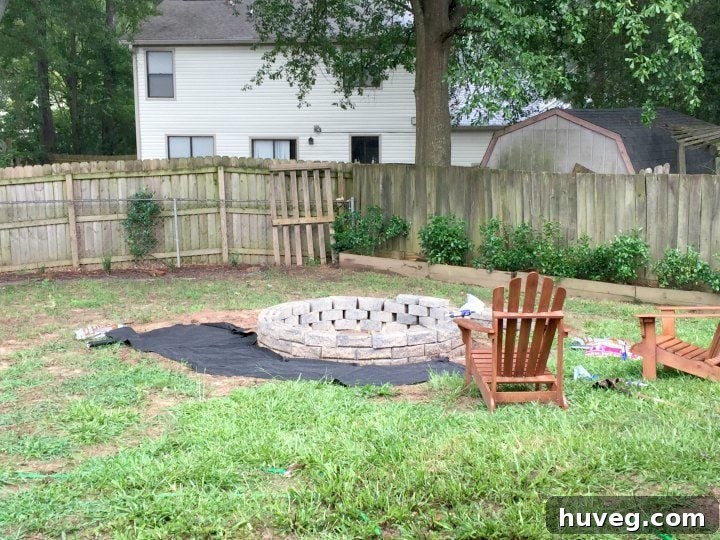 Using landscape fabric around the fire pit, I planned the seating area, visualizing the span with two Adirondack chairs.