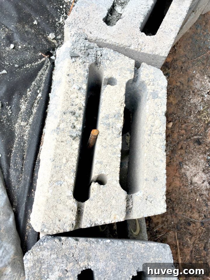 Rebar strategically placed within the stones helps stabilize and reinforce the fire pit wall, enhancing its long-term durability.