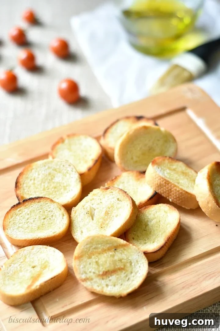Slices of fresh baguette ready to be toasted for homemade crostini.