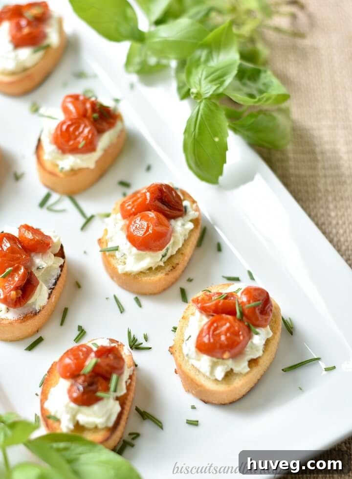 Platter of Herbed Goat Cheese Crostini with Roasted Cherry Tomatoes, ready to serve.