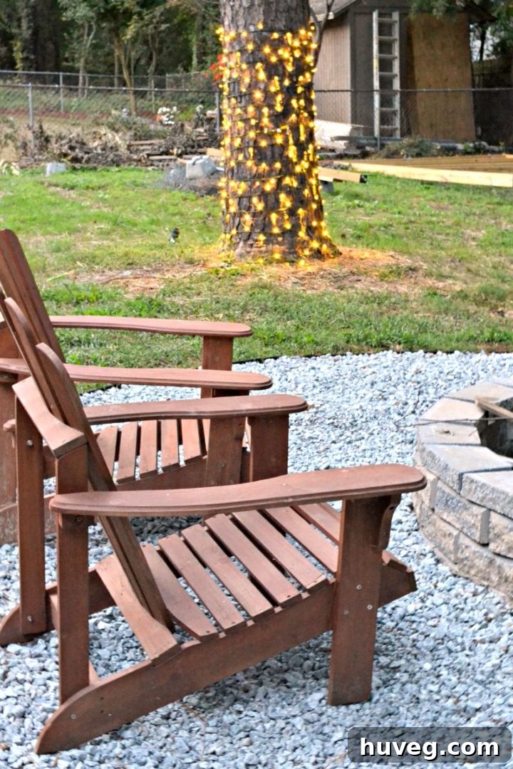 New fire pit filled with gravel and new string lights around the central tree