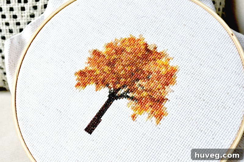 Autumn tree cross stitch close-up, highlighting the texture and color blending of the stitches.
