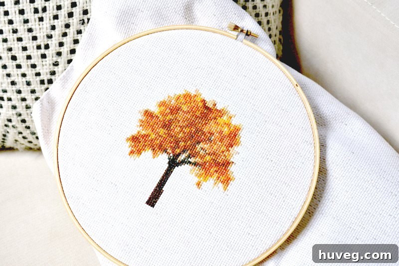 Screenshot of a digital cross stitch pattern for a fall tree, illustrating the detailed grid and color codes.