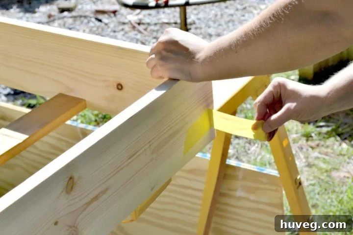 Removing painter's tape from the exterior of the drink station frame