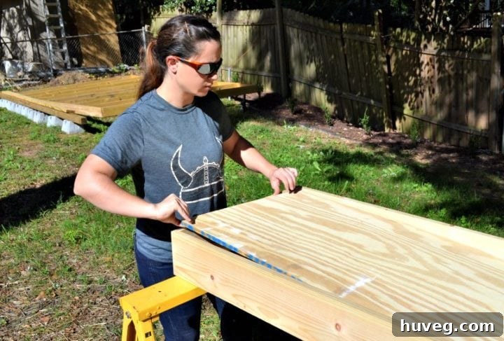 Moving the plywood into place for the bottom of the DIY drink station