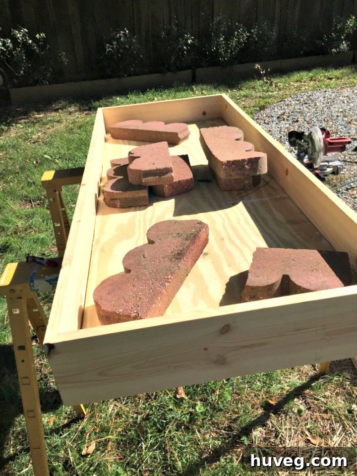 Weighing down plywood into the base of the outdoor drink station
