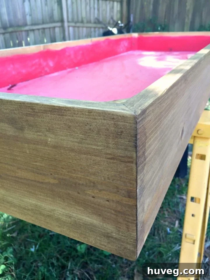 Staining the wooden components of the outdoor drink station