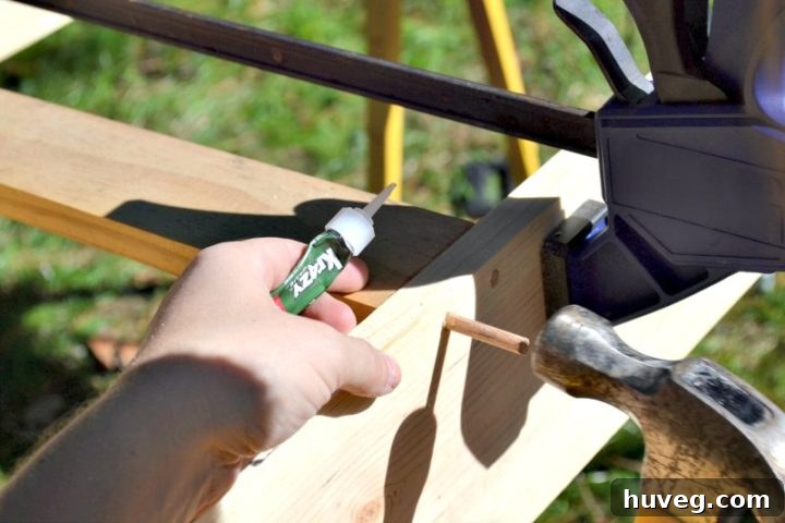 Securing dowels with a hammer for added bottom support in the drink tray