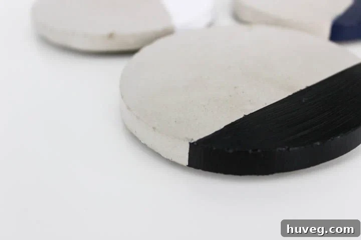 Close-up of a DIY concrete coaster, highlighting its texture and painted design.