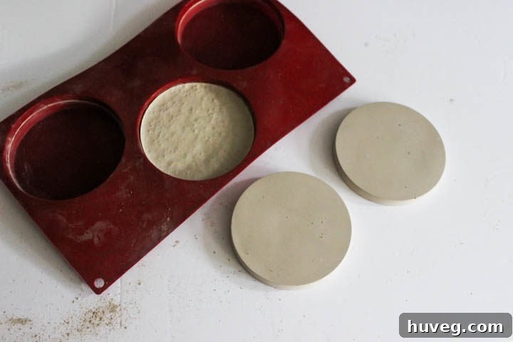 After concrete sets, gently pop the newly formed coasters out of their molds.