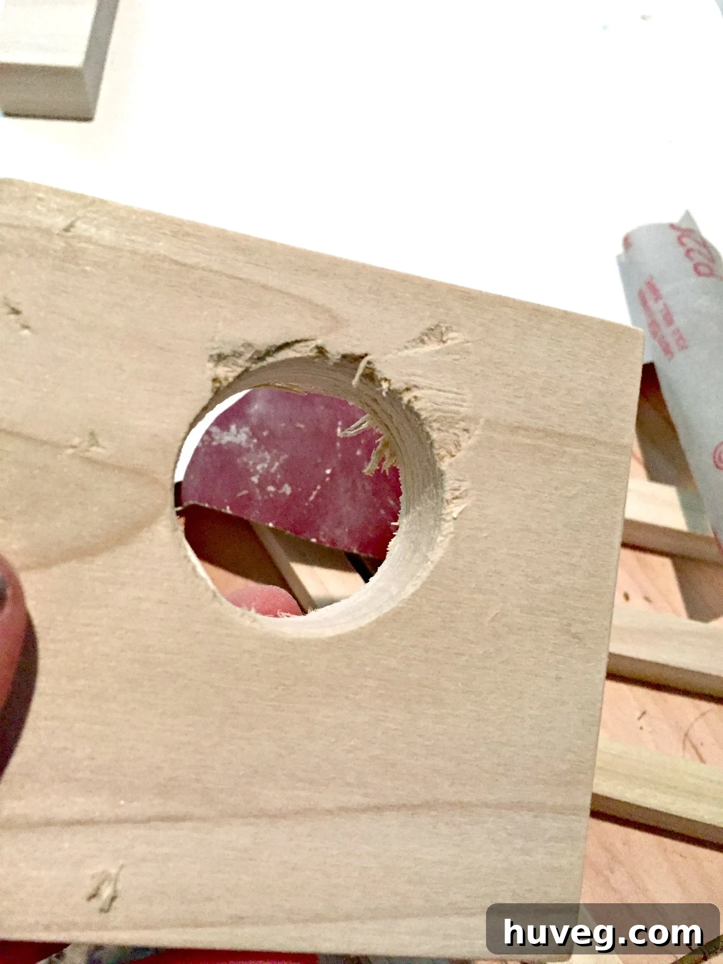 Unsuccessful first attempt at drilling a wine rack hole by hand, showing rough edges