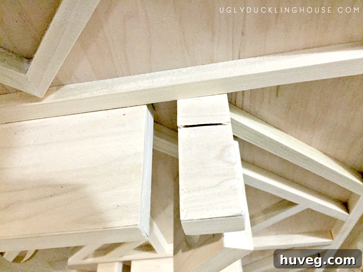 Split wood on the underside of a wine rack support, caused by a screw