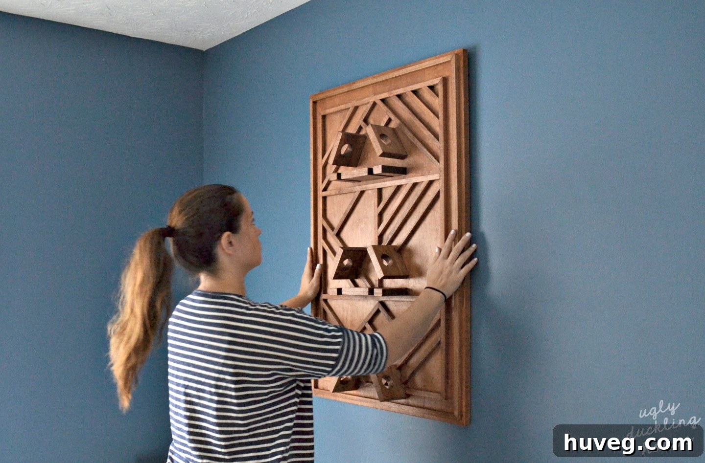 Mounting a plywood art wine rack to the dining room wall using heavy-duty cleats