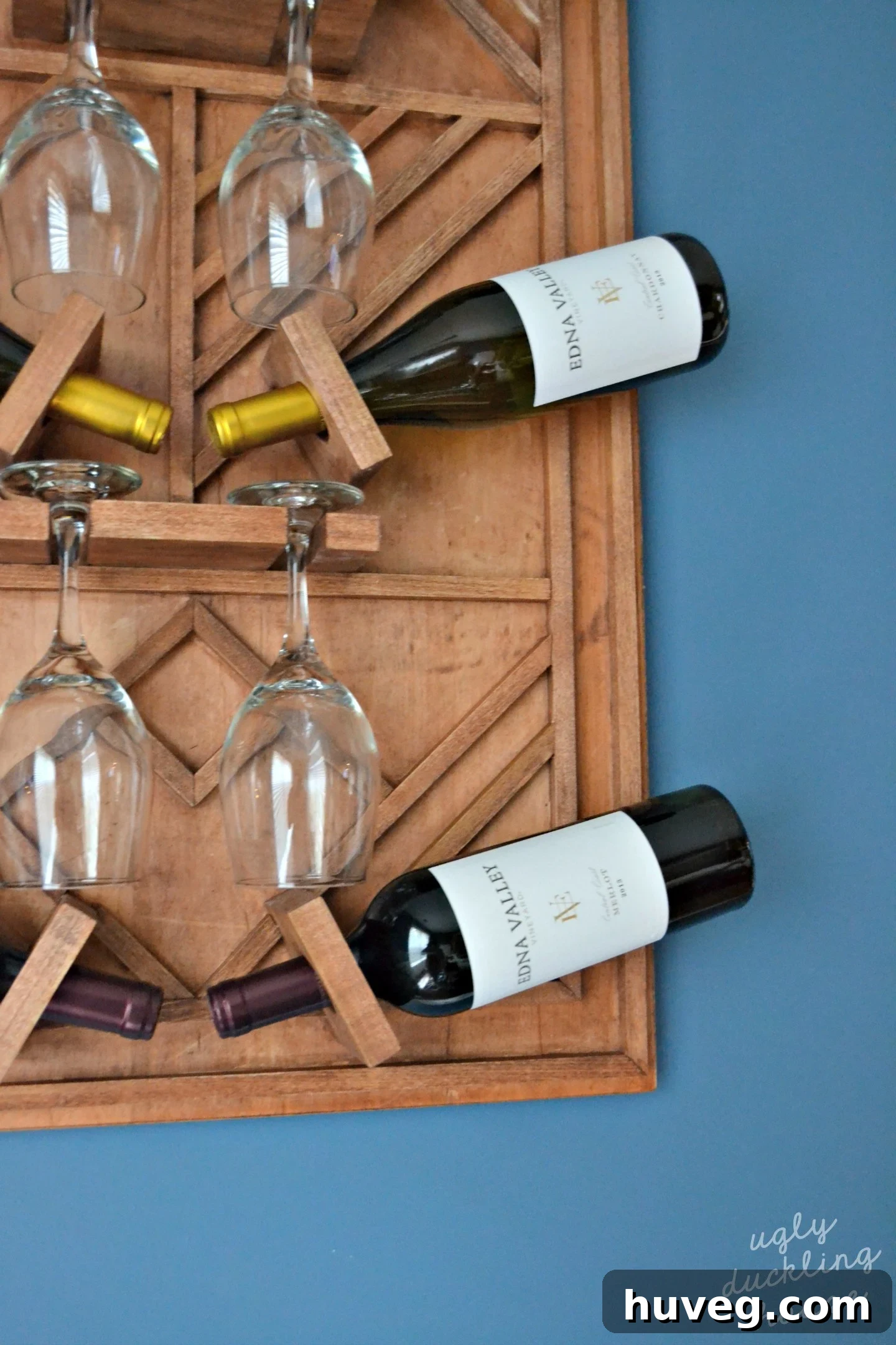 Loaded wine rack with Edna Valley Vineyard bottles and wine glasses, ready for entertaining