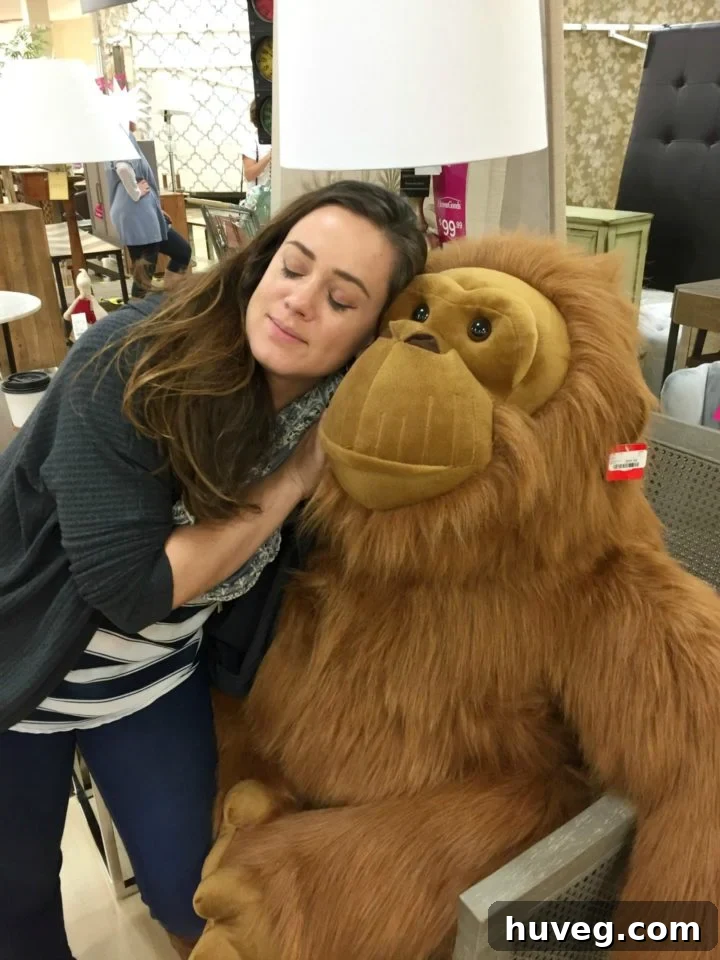 Friends hugging a giant stuffed ape at Homegoods