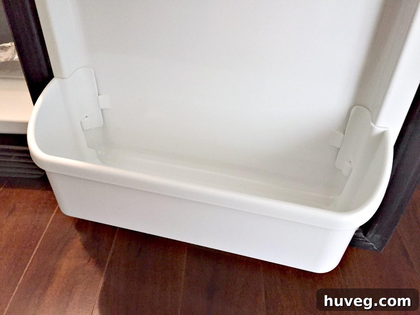 replacing bottom drawer in fridge, demonstrating a simple home repair