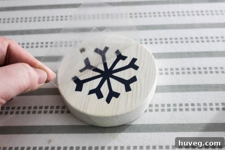 Completed white washed reindeer ornaments with navy vinyl designs