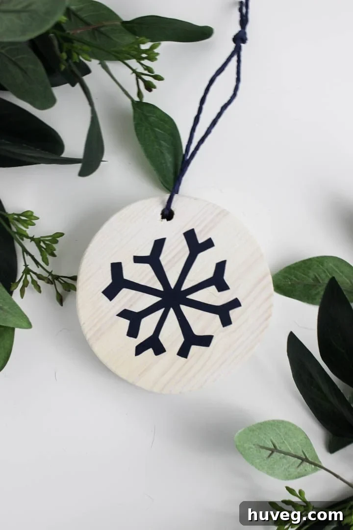 Close-up of a white washed reindeer ornament hanging on a Christmas tree
