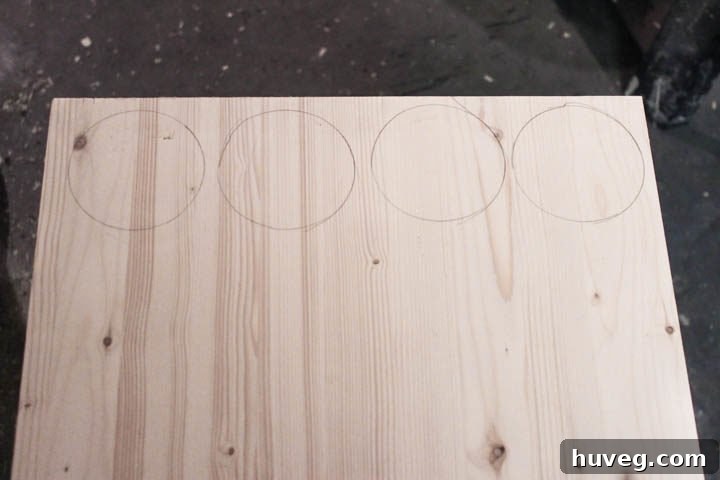 Tracing circles onto a wooden board for DIY ornaments