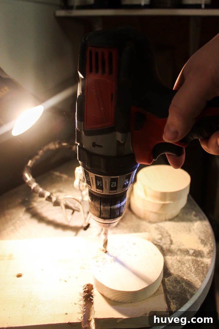 Drilling a small hole at the top of a wooden ornament