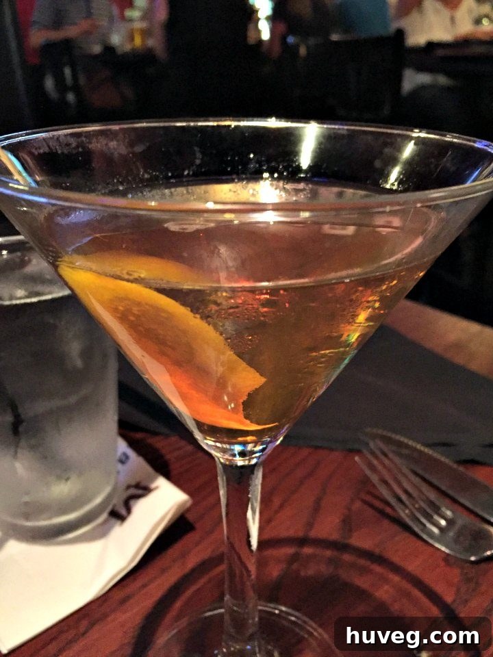 Pear Manhattan cocktail served at Marlow's Tavern, showcasing its rich amber color