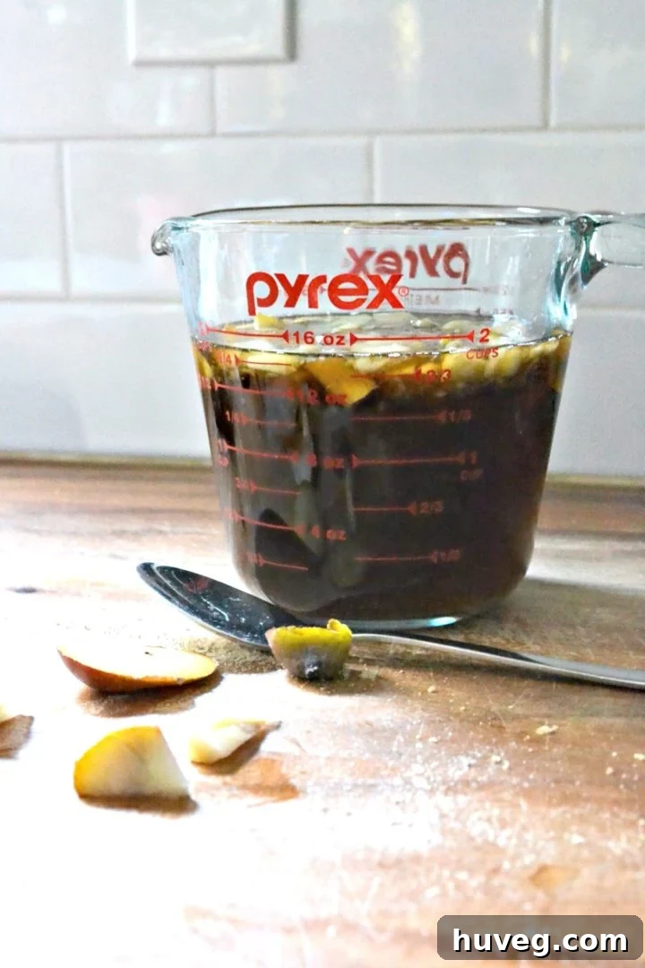 Homemade brown sugar simple syrup cooling in a pourable container for easy use